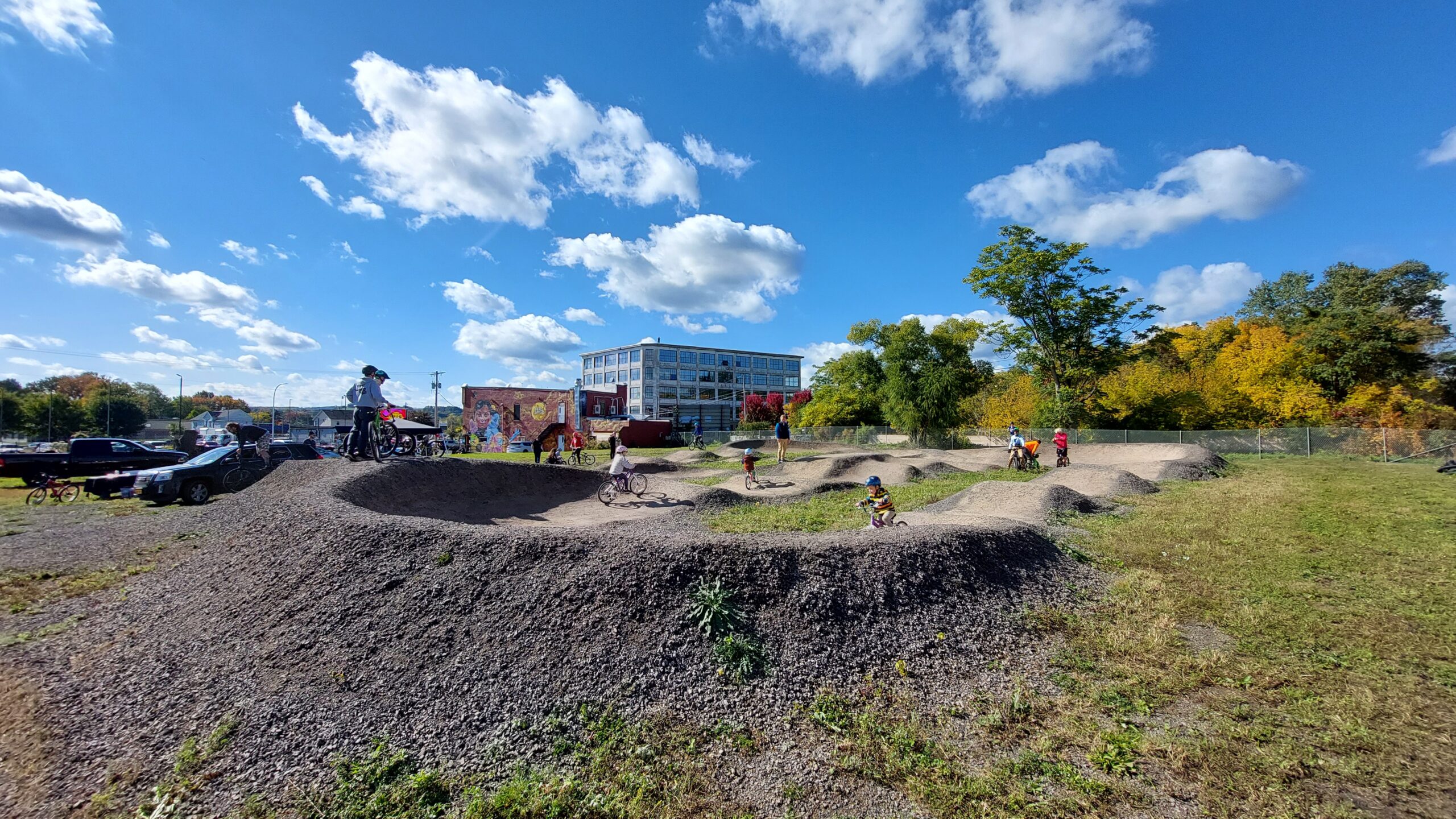 Community riding the pump track on opening day.